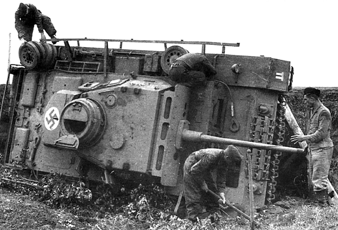 Pzkmpfw III Ausf. J or L which rolled onto its side during combat. Notice the swastika painted on the turret bustle storage bin and the Panzer division tactical marking on the front fender.