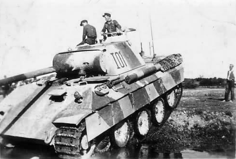 An early model Panzerkampfwagen V 'Panther' Ausf. A Number I01. Due to the numbering, this is clearly the 1st Battalion Commander's vehicle for whatever Panzer Division it is part of. I have no real documentation for the image, but from what can be extrapolated from the image, it's likely between 1943 - 1944 (due to the vehicle model and camouflage pattern).