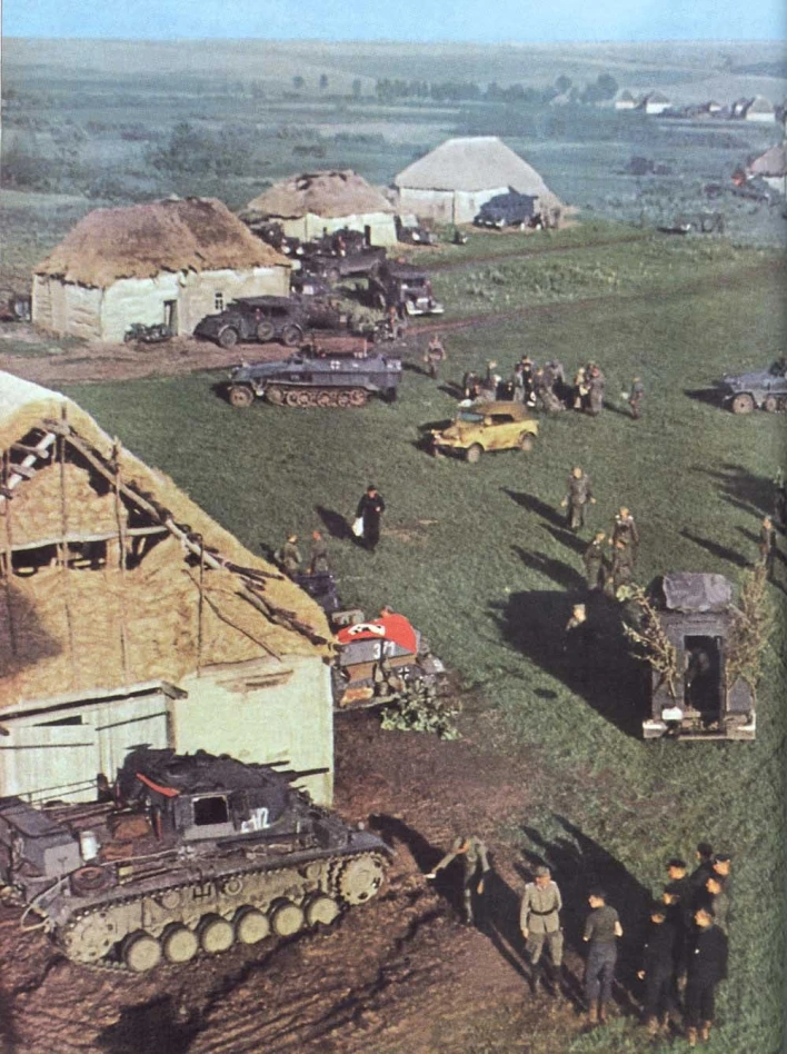 [Photo 1 - An actual colour photo demonstrating all these vehicles in Dunkelgrau during 1941. A tactical mark on the Pz Kpfw III in the foreground, next to the building seems to indicate these were from the 7th Panzer Division, but I have no supporting documentation. Also notice how the kubelwagen (probably used for scouting) is done in a different colour scheme.] 